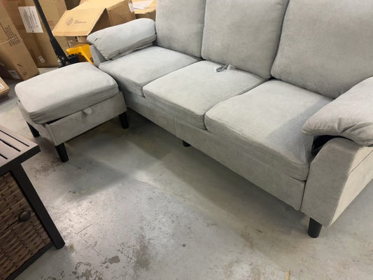 Light grey sofa and foot stool with storage